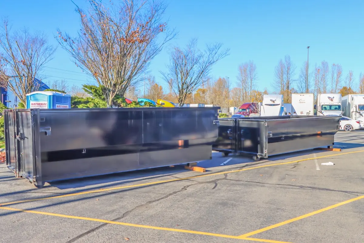 Professional dumpster rental service with roll-off container on residential driveway in Lakeland Highlands